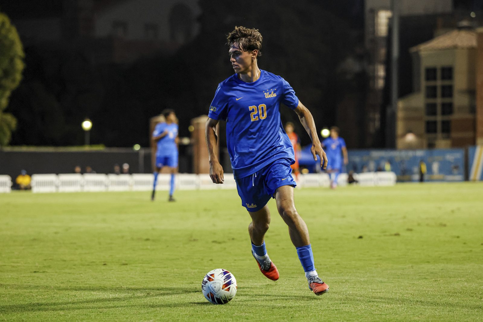 UCLA men&rsquo;s soccer player on the ball during an NCAA match